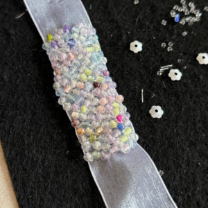 pastel impressionist garden iridescent caviar beaded trim on shimmering organza